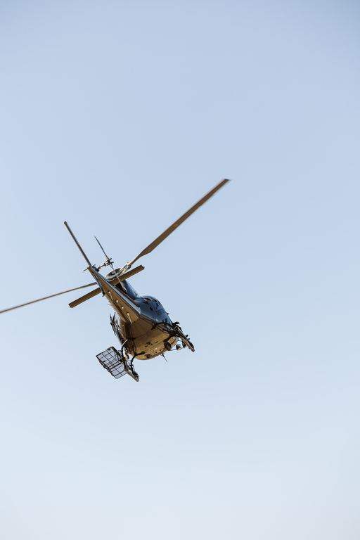 Helicopter in flight above the mountains