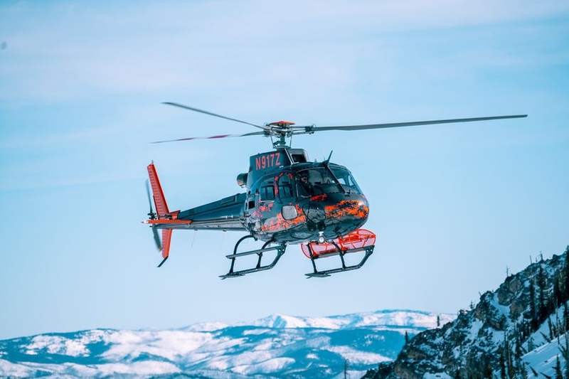 Helicopter above snow-covered peaks