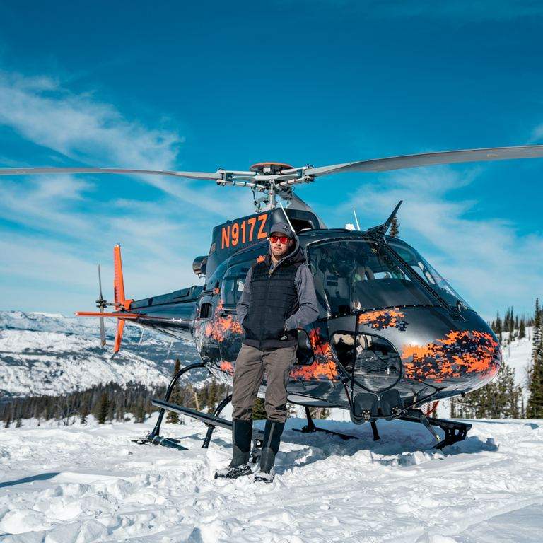Crew and helicopter on a snow-covered landing zone
